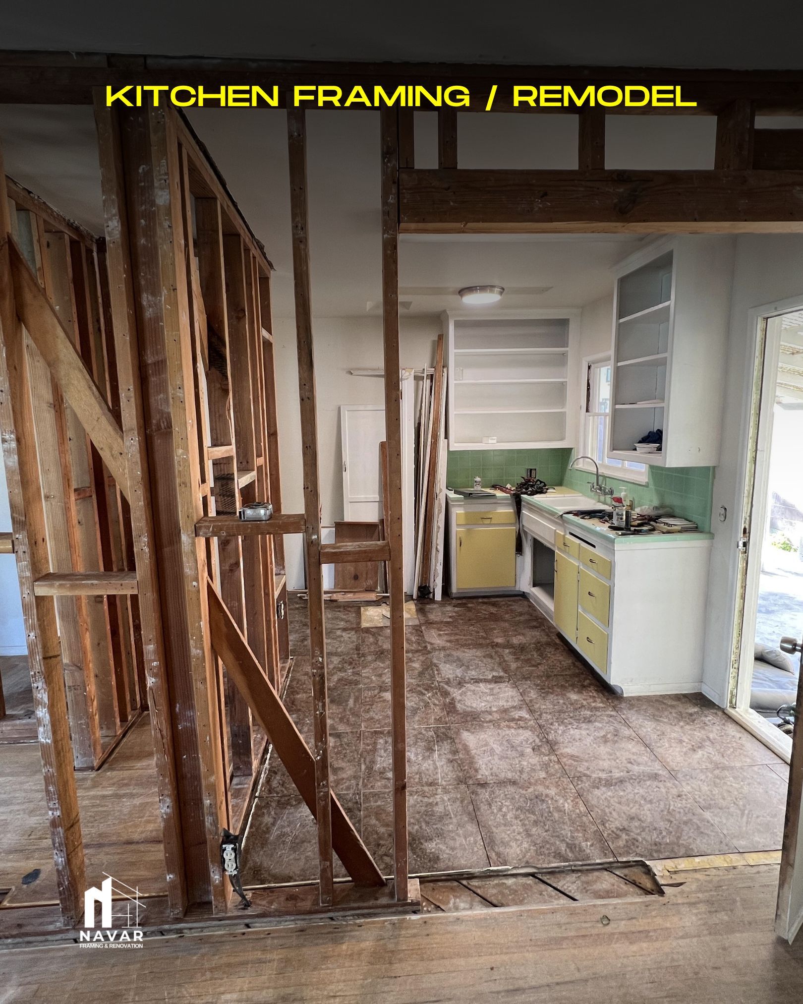 Carpenters erecting wooden framing for a kitchen remodel project.