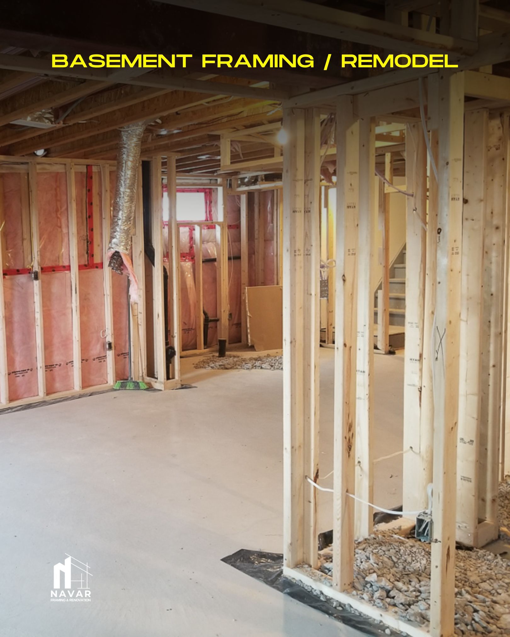 Construction crew framing a basement with insulated wall studs and subflooring.